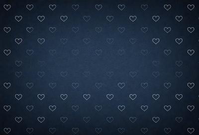 The primary subject of the image is a pattern of hearts. The setting is a blue background, which creates a visually appealing contrast with the hearts. The visual style is a combination of a photo and digital art, as the hearts are arranged in a way that resembles a digital artwork. The colors are predominantly blue, which adds to the overall mood of the image.