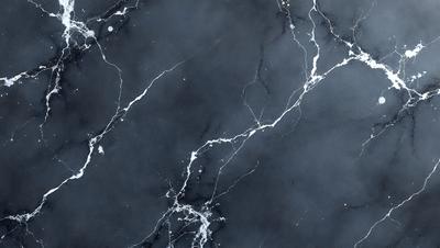 The primary subject of the image is a marble countertop with a black and white pattern. The setting is a kitchen, and the visual style is a photo. The countertop has a black and white marble pattern, and the overall atmosphere is elegant and sophisticated.