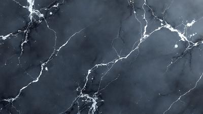 The primary subject of the image is a marble countertop with a black and white pattern. The setting is a kitchen, and the visual style is a photo. The countertop has a black and white marble pattern, and the overall atmosphere is elegant and sophisticated.