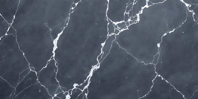 The image features a marble countertop with a black and white pattern. The countertop appears to be a part of a kitchen or bathroom setting. The visual style of the image is a photo, capturing the intricate details of the marble countertop. The colors and mood of the image are predominantly black and white, giving it a classic and elegant appearance.