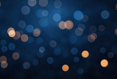 The primary subject of the image is a blue background with a pattern of bright lights. The setting appears to be a nighttime cityscape, with the lights creating a vibrant and lively atmosphere. The visual style of the image is a combination of photo and digital art, as it captures the essence of a city at night. The colors and mood of the image are predominantly blue and bright, with the lights creating a sense of energy and excitement.