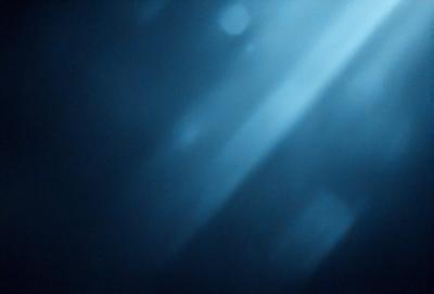 The primary subject of the image is a blue background with a few white lights shining through it. The setting appears to be a dark room with the lights creating a unique visual effect. The visual style of the image is a combination of digital art and illustration, as the lights are depicted as white lines or shapes. The colors and mood of the image are predominantly dark and moody, with the blue background and white lights creating a sense of depth and contrast.