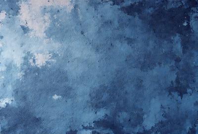 The primary subject of the image is a blue sky with clouds. The setting is a cloudy blue sky, and the visual style is a painting or drawing. The colors and mood are predominantly blue, creating a calm and serene atmosphere.