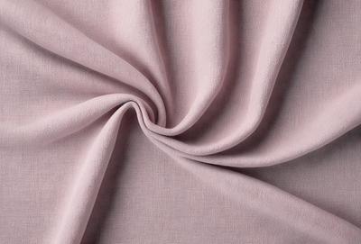 The primary subject of the image is a piece of pink fabric. The setting is a white background, and the visual style is a close-up of the fabric. The colors and mood of the image are predominantly pink, creating a warm and inviting atmosphere.