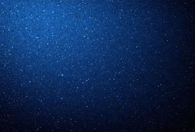 The primary subject of the image is the night sky, which is filled with stars. The setting is a dark, star-filled sky, and the visual style is a photo. The colors and mood of the image are predominantly dark and serene, with the stars providing a sense of depth and beauty.