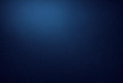 The primary subject of the image is a large, dark blue expanse of water. The setting is a vast, open ocean with no visible land or other objects. The visual style is a realistic representation of the ocean, with no indication of digital manipulation or artistic elements. The colors and mood of the image are predominantly dark and moody, with the deep blue of the water creating a sense of vastness and tranquility.