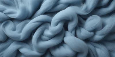 The primary subject of the image is a blue yarn or thread, which is the main focus of the scene. The setting is a close-up of the yarn, showcasing its texture and color. The visual style is a detailed, artistic representation of the yarn, possibly as a digital art or illustration. The dominant colors are blue and white, creating a calm and soothing atmosphere.