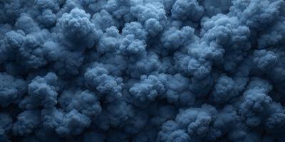 The primary subject of the image is a large, blue cloud. The cloud is the main object, scene, or focus of the image. The setting or background of the image is a blue sky, which provides a contrasting backdrop for the cloud. The visual style of the image is a photo, as it captures the cloud in its natural environment. The dominant colors in the image are blue and white, creating a calm and serene atmosphere.