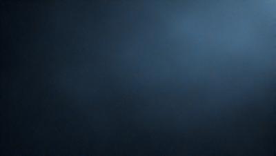 The primary subject of the image is a dark blue sky. The setting is a cloudy sky, with no visible land or objects. The visual style is a photo, capturing the natural beauty of the sky. The colors and mood are predominantly dark and moody, with the blue hue creating a sense of calmness and tranquility.