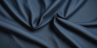 The primary subject of the image is a blue fabric, possibly a piece of cloth or a curtain. The setting is a dark room, and the visual style appears to be a close-up of the fabric. The colors and mood of the image are predominantly dark and moody, with the blue fabric being the main focus.