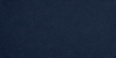 The primary subject of the image is a blue cloth, which is the main object, scene, or focus of the image. The setting or background is a dark blue surface, which creates a moody atmosphere. The visual style of the image is a photo, as it captures the details of the blue cloth. The colors and mood of the image are predominantly dark blue, creating a sense of calmness and tranquility.