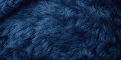 The primary subject of the image is a blue, furry fabric. The setting is a close-up of the fabric, showcasing its texture and color. The visual style is a detailed, up-close view of the fabric. The colors and mood of the image are predominantly blue, creating a calm and soothing atmosphere.
