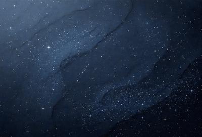 The primary subject of the image is a night sky filled with stars. The setting is a dark, starry background, and the visual style is a painting or drawing. The colors and mood of the image are predominantly dark and moody, with the stars providing a sense of depth and beauty.
