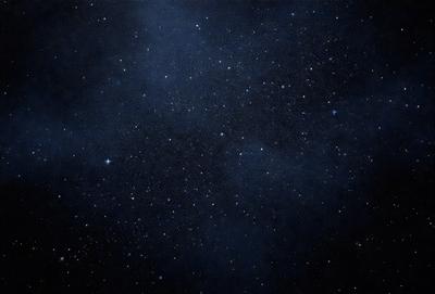 The primary subject of the image is the night sky filled with stars. The setting is a dark, star-filled sky, and the visual style is a black and white photo. The colors and mood of the image are predominantly dark and moody, with the stars being the main focus.