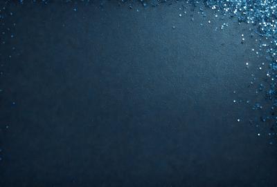 The primary subject of the image is a blue background with a pattern of glittering blue stars. The setting is a dark background, which contrasts with the bright blue stars. The visual style is a digital art or illustration, as the blue stars create a unique and eye-catching pattern. The colors and mood of the image are predominantly blue, with a touch of glittering sparkle from the stars, creating a sense of depth and visual interest.