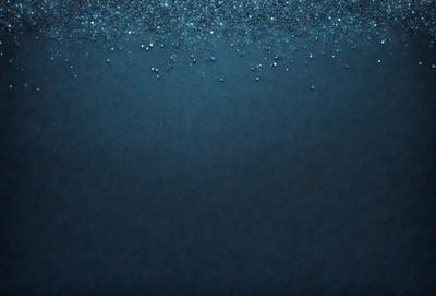 The primary subject of the image is a blue background with a pattern of glittering blue and white dots. The setting is a dark background, which contrasts with the bright blue dots. The visual style is a combination of a photo and digital art, creating a unique and eye-catching design. The colors and mood of the image are predominantly blue, with the glittering dots adding a touch of brightness and energy to the overall atmosphere.