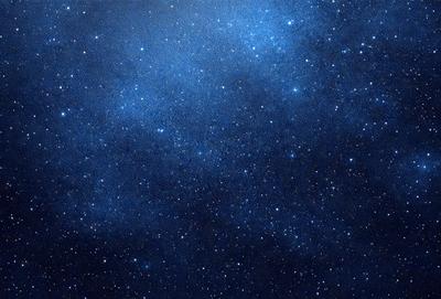 The primary subject of the image is the night sky filled with stars. The setting is a dark, star-filled sky, and the visual style is a photo of the night sky. The colors and mood of the image are predominantly dark and serene, with the stars providing a sense of wonder and tranquility.