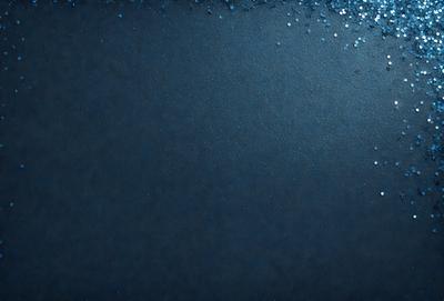 The primary subject of the image is a blue background with a pattern of glittering blue stars. The setting is a dark background, which contrasts with the bright blue stars. The visual style is a combination of a photo and digital art, creating a unique and eye-catching design. The colors and mood of the image are predominantly blue, with the glittering stars adding a touch of sparkle and excitement to the overall atmosphere.