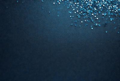 The primary subject of the image is a blue background with a pattern of blue glittery stars. The setting is a dark blue background, and the visual style appears to be a digital art or illustration. The colors and mood of the image are predominantly dark blue and glittery, creating a sense of depth and intrigue.