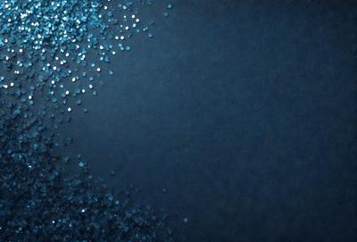 The primary subject of the image is a blue background with a pattern of blue and white glittery dots. The setting is a dark blue background, which creates a contrast with the glittery dots. The visual style is a combination of a photo and digital art, as the dots appear to be digitally created and placed on the blue background. The colors and mood of the image are predominantly dark blue and glittery, giving it a somewhat mysterious and captivating atmosphere.