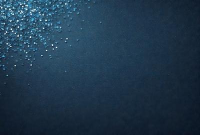The primary subject of the image is a blue background with a pattern of glittering blue and white stars. The setting is a dark blue background, which contrasts with the bright stars. The visual style is a combination of a photo and digital art, creating a unique and eye-catching pattern. The colors and mood of the image are predominantly dark blue and white, with the glittering stars adding a touch of brightness and energy to the overall atmosphere.