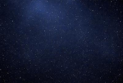 The primary subject of the image is the night sky, which is filled with stars. The setting is a dark, starry night, with no visible landmarks or other objects. The visual style is a black and white photo, which adds a sense of timelessness and elegance to the scene. The colors and mood are predominantly dark and serene, with the stars providing a sense of wonder and tranquility.