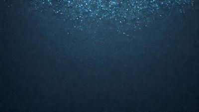 The primary subject of the image is the ocean, with a focus on the water and its surface. The setting is underwater, with a blue background that creates a serene and calming atmosphere. The visual style is a close-up of the water, showcasing the beauty of the ocean. The colors and mood are predominantly blue, which adds to the tranquil and peaceful ambiance of the scene.