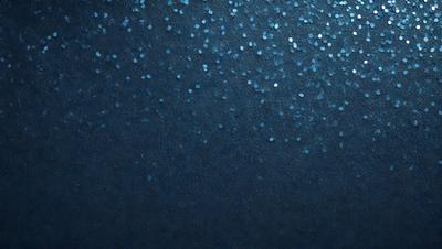 The primary subject of the image is a blue background with a pattern of glittering stars. The setting is a dark, starry night, and the visual style is a combination of a photo and digital art. The colors and mood of the image are predominantly dark and moody, with the blue background and glittering stars creating a sense of depth and mystery.