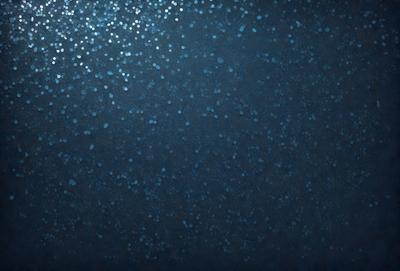 The primary subject of the image is a blue background with a pattern of white dots. The setting appears to be a dark, possibly underwater, environment. The visual style of the image is a combination of a photo and digital art, creating a unique and intriguing appearance. The dominant colors are blue and white, with the blue background and white dots creating a calming and serene atmosphere.
