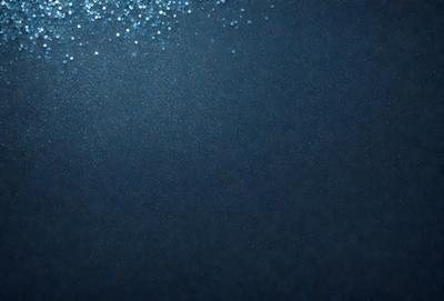 The primary subject of the image is a blue ocean with a few white specks. The setting is a dark blue background, which creates a contrast with the white specks. The visual style is a photo of the ocean, capturing the beauty of the water and the specks. The colors and mood of the image are predominantly dark blue, with the white specks adding a touch of brightness and contrast.