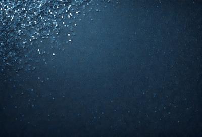 The primary subject of the image is a blue background with a pattern of glittering blue and white beads. The setting is a dark room, and the visual style appears to be a digital art or illustration. The dominant colors are blue and white, creating a calm and serene atmosphere.