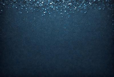 The primary subject of the image is a blue background with a pattern of silver glittery dots. The setting is a dark blue background, and the visual style appears to be a digital art or illustration. The dominant colors are blue and silver, creating a calm and serene atmosphere.