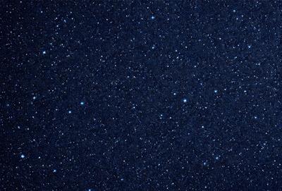 The primary subject of the image is the night sky, which is filled with stars. The setting is a dark, star-filled sky, and the visual style is a photo of the night sky. The colors and mood of the image are predominantly dark and serene, with the stars providing a sense of wonder and tranquility.
