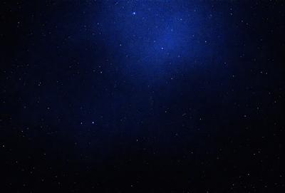 The primary subject of the image is the night sky filled with stars. The setting is a dark, star-filled sky, and the visual style is a photo of the night sky. The colors and mood of the image are predominantly dark and serene, with the stars providing a sense of wonder and tranquility.