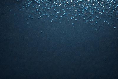 The primary subject of the image is a blue background with a pattern of glittering blue stars. The setting is a dark blue sky, and the visual style is a digital art or illustration. The colors and mood of the image are predominantly dark and moody, with the blue stars adding a touch of brightness and interest to the overall atmosphere.