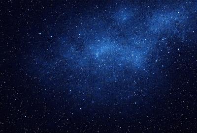 The primary subject of the image is the night sky filled with stars. The setting is a dark, star-filled sky, and the visual style is a photo of the night sky. The colors and mood of the image are predominantly dark and serene, with the stars providing a sense of wonder and tranquility.