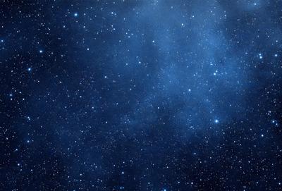 The primary subject of the image is the night sky filled with stars. The setting is a dark, star-filled sky, and the visual style is a photo of the night sky. The colors and mood of the image are predominantly dark and serene, with the stars providing a sense of wonder and tranquility.