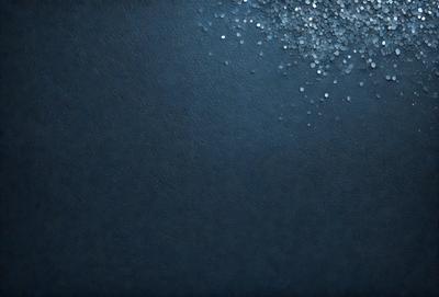 The primary subject of the image is a blue background with a pattern of glittering, shiny, or sparkling objects. The setting appears to be a dark or black background, which contrasts with the blue and glittering objects. The visual style of the image is a combination of a photo and digital art, as it features a pattern of glittering objects that are not typically found in a photo. The colors and mood of the image are predominantly dark and moody, with the blue background and glittering objects