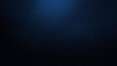 The primary subject of the image is a dark blue sky with no clouds. The setting is a vast, open space with no visible landmarks or objects. The visual style is a simple, clean, and minimalistic representation of the sky. The colors and mood are predominantly dark and moody, with the blue sky being the main focus of the image.
