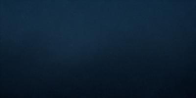 The primary subject of the image is a large body of water, which appears to be a dark blue ocean. The setting is a vast expanse of water, with no visible land or other objects in the background. The visual style of the image is a close-up of the water, emphasizing its vastness and depth. The colors and mood of the image are dark and moody, with the deep blue water creating a sense of calmness and tranquility.
