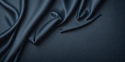 The primary subject of the image is a piece of blue fabric, possibly a piece of clothing or a curtain. The setting is a dark background, which contrasts with the blue fabric. The visual style appears to be a close-up of the fabric, showcasing its texture and details. The colors and mood of the image are predominantly dark and moody, with the blue fabric being the main focal point.