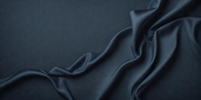 The primary subject of the image is a piece of blue fabric, which is the main object, scene, or focus of the image. The setting or background is a dark blue surface, which provides a contrasting backdrop for the fabric. The visual style of the image is a close-up of the fabric, showcasing its texture and details. The colors and mood of the image are predominantly dark blue, creating a moody and dramatic atmosphere.
