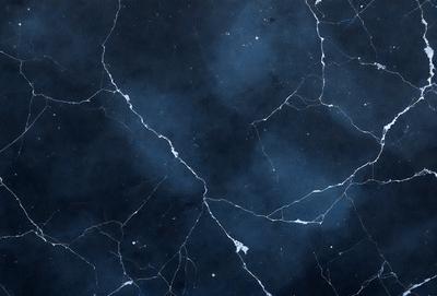 The primary subject of the image is a blue and white marbled wall. The setting is a dark room with a blue background. The visual style is a close-up of the marbled wall, showcasing its intricate patterns. The colors and mood of the image are predominantly dark and moody, with the blue and white marbled wall serving as the focal point.