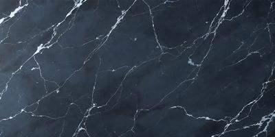 The primary subject of the image is a black marble countertop. The setting is a kitchen, with the countertop being the main focus of the scene. The visual style is a close-up of the marble countertop, showcasing its texture and pattern. The colors and mood of the image are predominantly dark, with the black marble countertop being the main source of contrast.