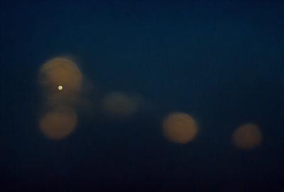 The primary subject of the image is a night sky filled with stars. The setting is a dark, cloudy night, with the stars shining brightly against the backdrop of the sky. The visual style is a photo, capturing the beauty of the night sky. The colors and mood of the image are predominantly dark and serene, with the stars providing a sense of wonder and tranquility.