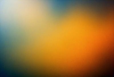 The primary subject of the image is a colorful, abstract background featuring a mix of yellow, orange, and blue hues. The setting is a wall, and the visual style appears to be a combination of digital art and illustration. The dominant colors and overall atmosphere of the image are vibrant and lively, creating a sense of energy and creativity.