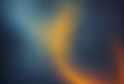 The primary subject of the image is a yellow and orange swirl pattern. The setting is a dark blue background, which contrasts with the vibrant colors of the swirl pattern. The visual style appears to be a digital art or illustration, as the swirl pattern is intricately detailed and the colors are rich and vivid. The overall atmosphere of the image is dynamic and energetic, with the swirl pattern capturing the viewer's attention and evoking a sense of movement and flow.