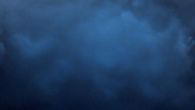 The primary subject of the image is a blue sky with clouds. The setting is a cloudy day, and the visual style is a photo. The dominant colors are blue and gray, creating a calm and serene atmosphere.
