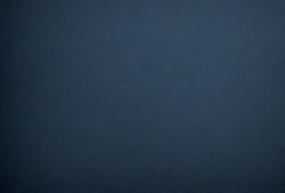 The primary subject of the image is a dark blue sky. The setting is a vast, open space with no visible landmarks or objects. The visual style is a natural, outdoor scene. The colors and mood are predominantly dark and moody, with the blue sky being the main focus of the image.