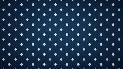 The primary subject of the image is a blue background with white polka dots. The setting is a dark blue background, and the visual style is a patterned design. The dominant colors are blue and white, creating a calm and soothing atmosphere.